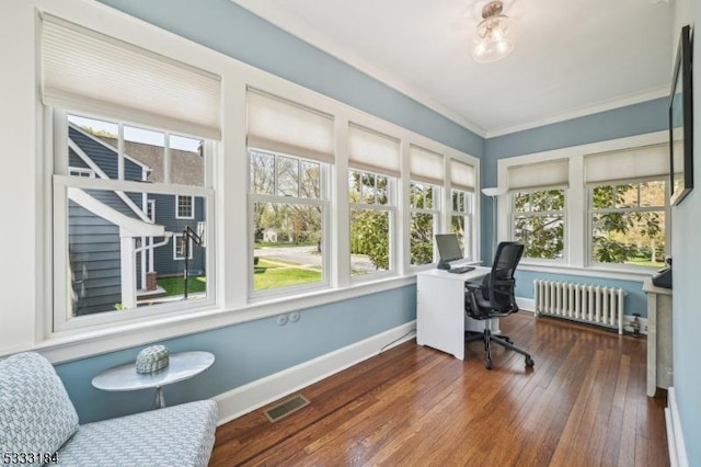 office area with visible vents, plenty of natural light, radiator, and hardwood / wood-style floors