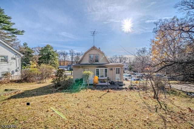 rear view of property with a lawn