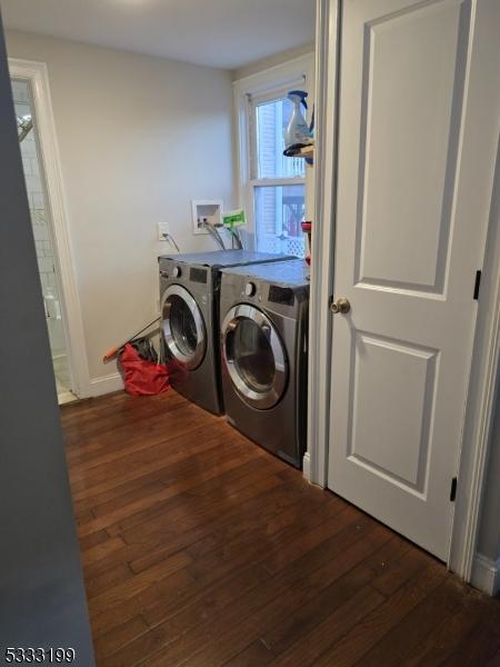 laundry area with independent washer and dryer and dark hardwood / wood-style floors