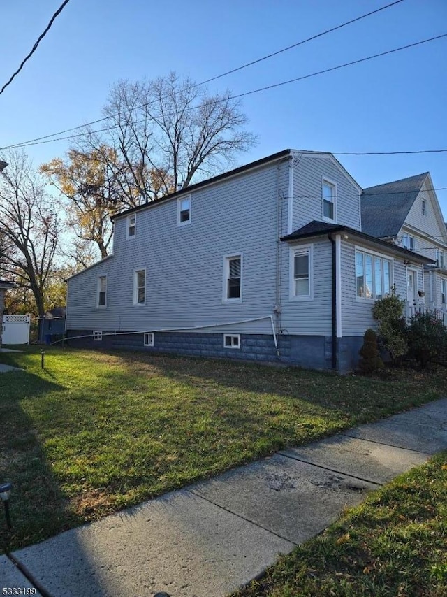 view of property exterior with a yard