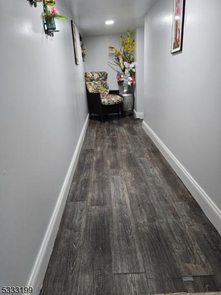 hallway featuring dark wood-type flooring