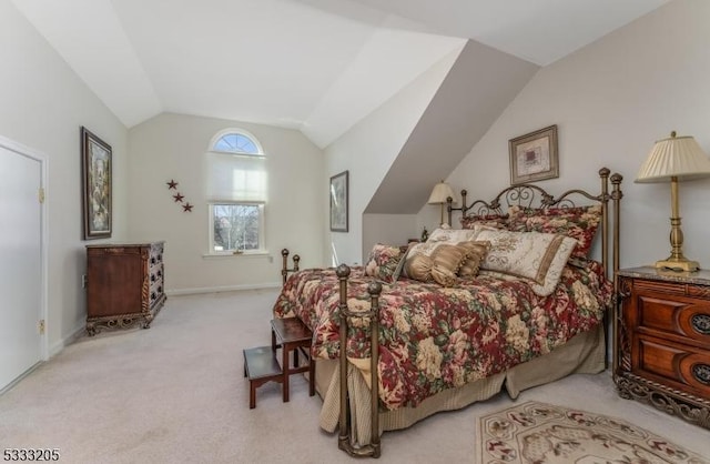 carpeted bedroom with vaulted ceiling