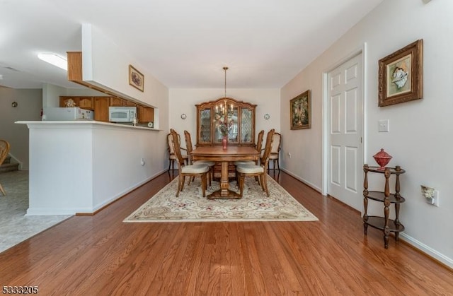 dining room featuring a notable chandelier and hardwood / wood-style flooring