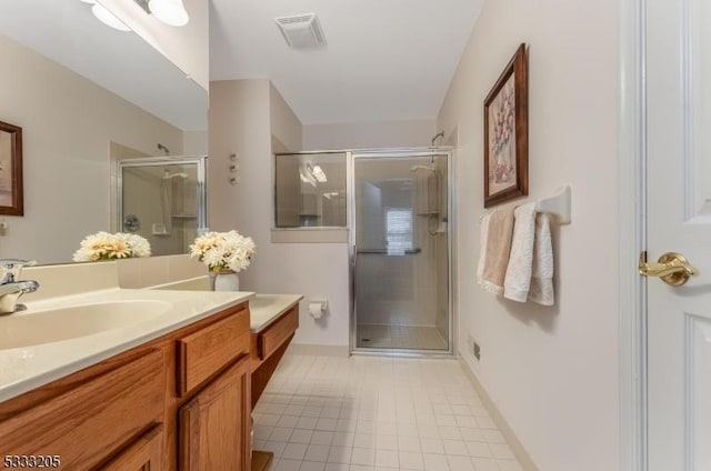 bathroom featuring a shower with door and vanity