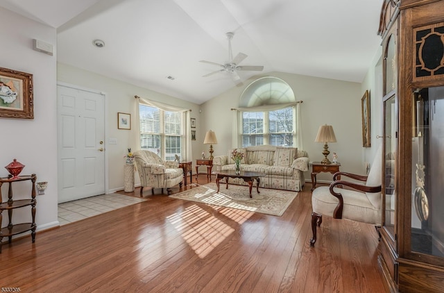 living room featuring ceiling fan, plenty of natural light, and light hardwood / wood-style flooring