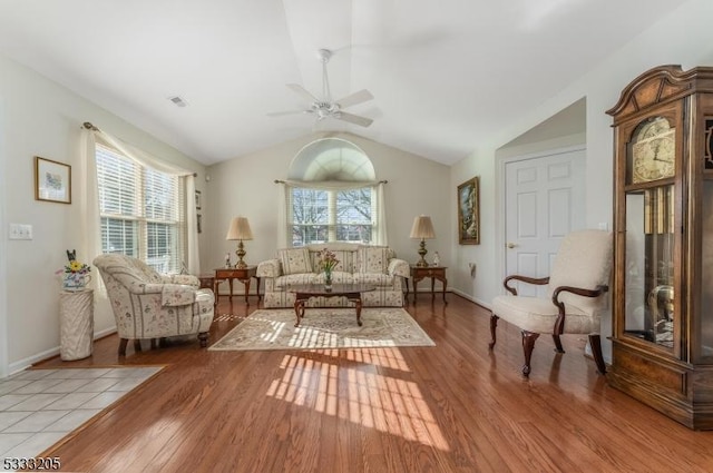 living room featuring ceiling fan, lofted ceiling, and light hardwood / wood-style floors