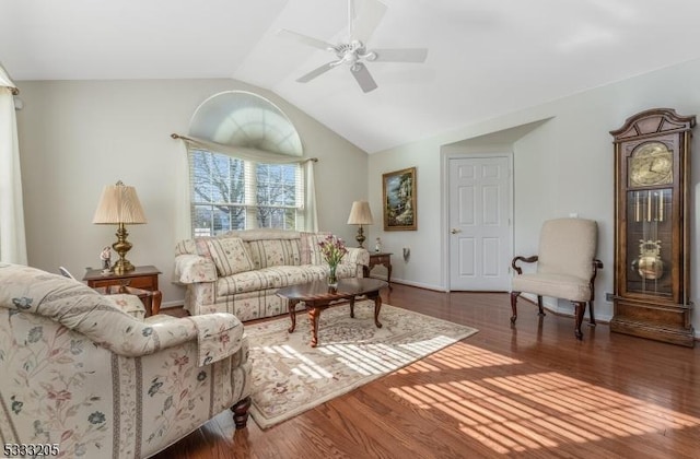 living room with lofted ceiling, ceiling fan, and dark wood-type flooring