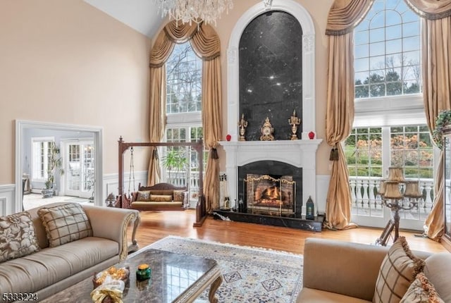 living room with a chandelier, light hardwood / wood-style flooring, and plenty of natural light