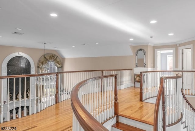 hall featuring hardwood / wood-style flooring and vaulted ceiling