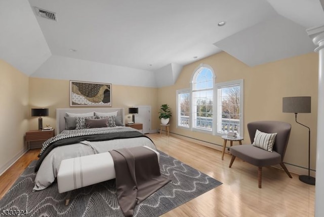 bedroom featuring light hardwood / wood-style flooring and lofted ceiling