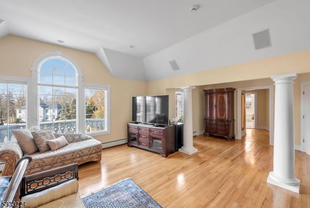 living room featuring baseboard heating, a healthy amount of sunlight, vaulted ceiling, and light hardwood / wood-style floors