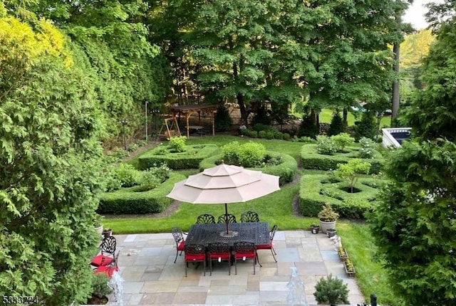 surrounding community featuring a patio area and a yard