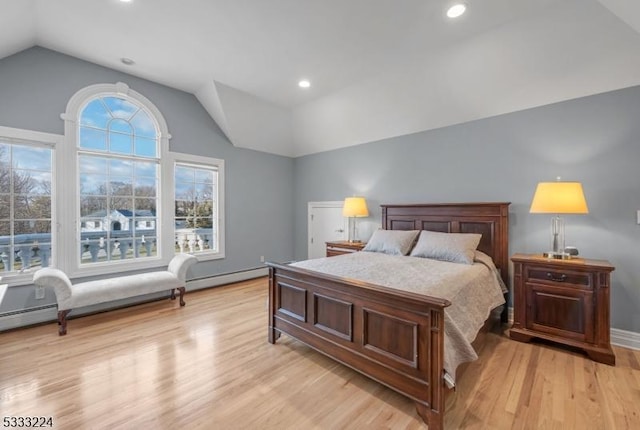 bedroom with light wood-type flooring and vaulted ceiling