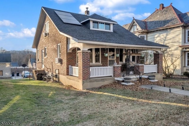 view of front of home featuring a front yard and a porch