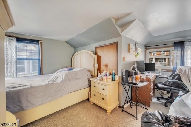 bedroom with multiple windows, light carpet, and lofted ceiling