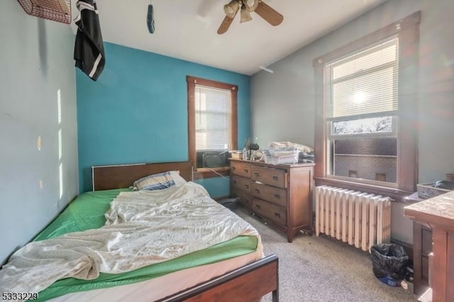 bedroom featuring ceiling fan, light colored carpet, and radiator