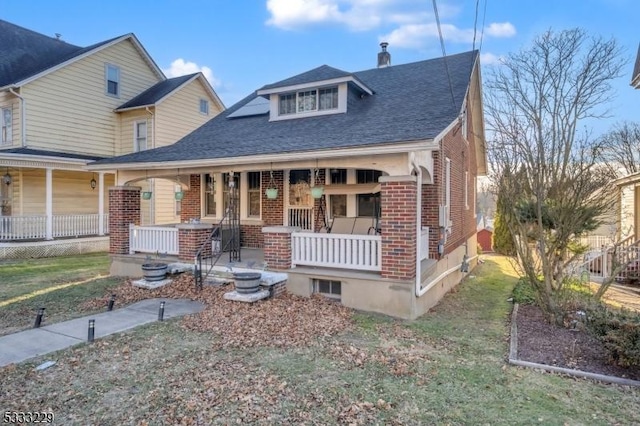 view of front of house with a front lawn and a porch