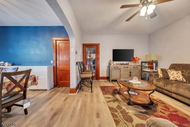 living room featuring ceiling fan and light hardwood / wood-style flooring