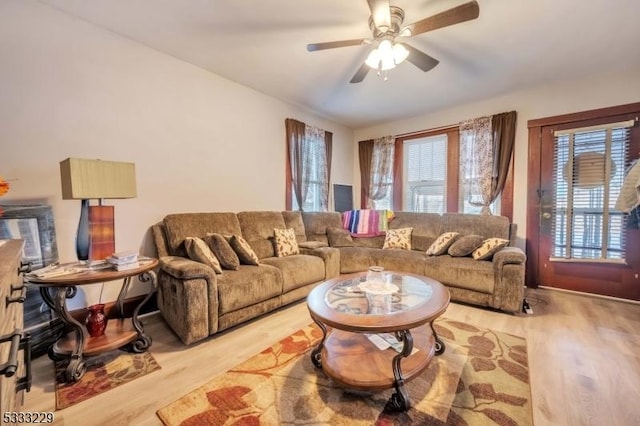 living room featuring ceiling fan and light hardwood / wood-style floors