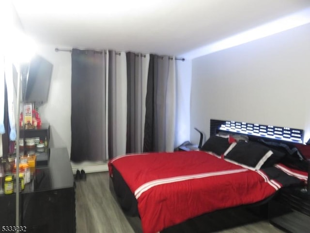 bedroom with wood-type flooring