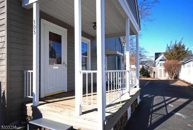 view of exterior entry with a porch