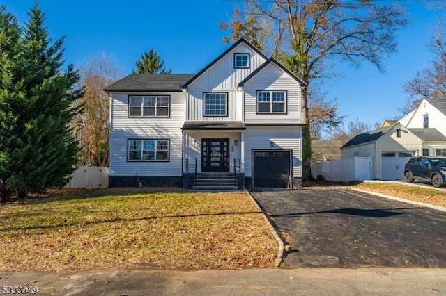 view of front property featuring a front lawn and a garage