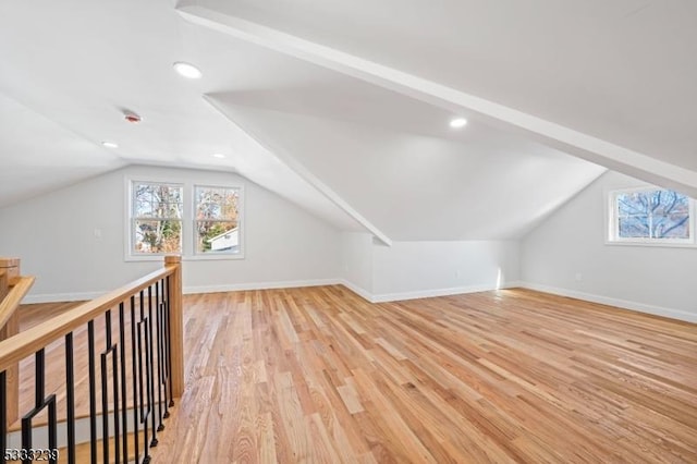 bonus room with lofted ceiling, a healthy amount of sunlight, and light hardwood / wood-style floors