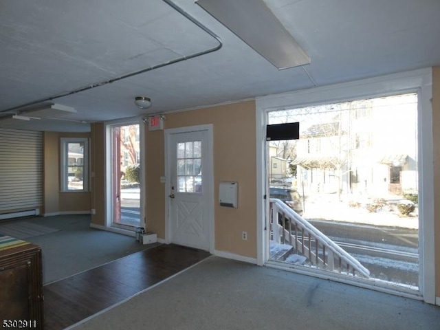 interior space featuring a baseboard radiator and dark carpet