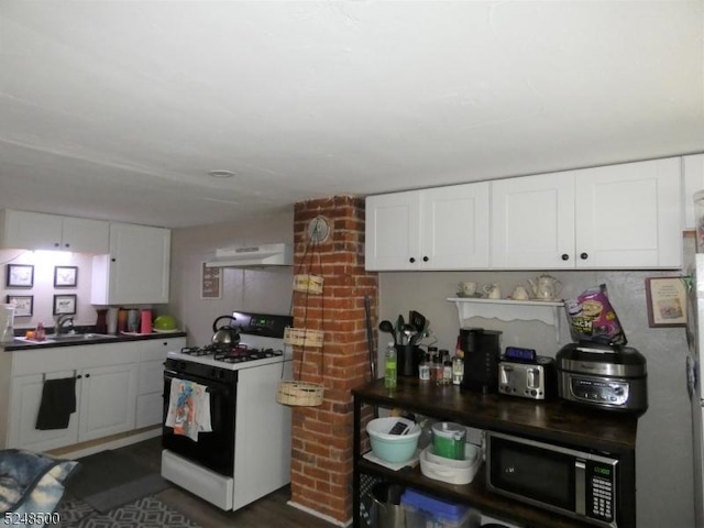 kitchen with sink, white gas range oven, and white cabinetry