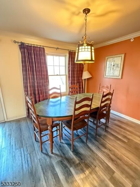 dining room featuring crown molding and hardwood / wood-style flooring