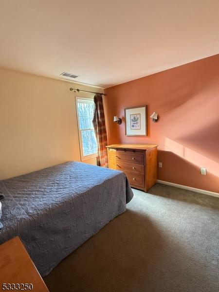 bedroom featuring dark carpet