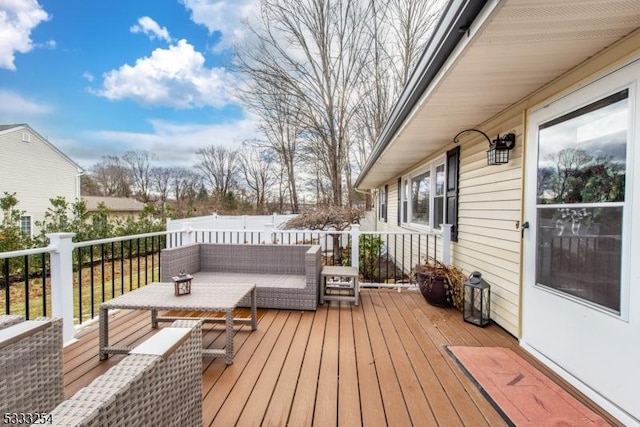 wooden terrace with an outdoor living space