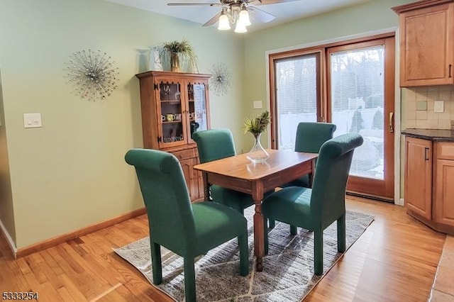 dining area with ceiling fan and light wood-type flooring