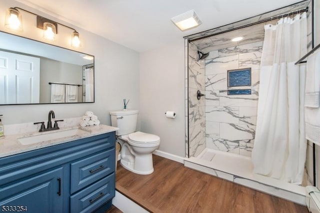 bathroom featuring vanity, hardwood / wood-style floors, toilet, and walk in shower