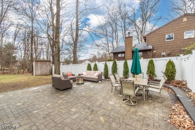 view of patio with an outdoor hangout area and a storage unit