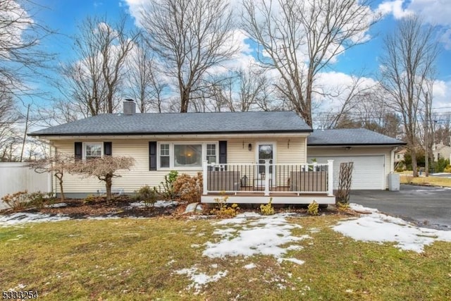 single story home with a garage and a front lawn