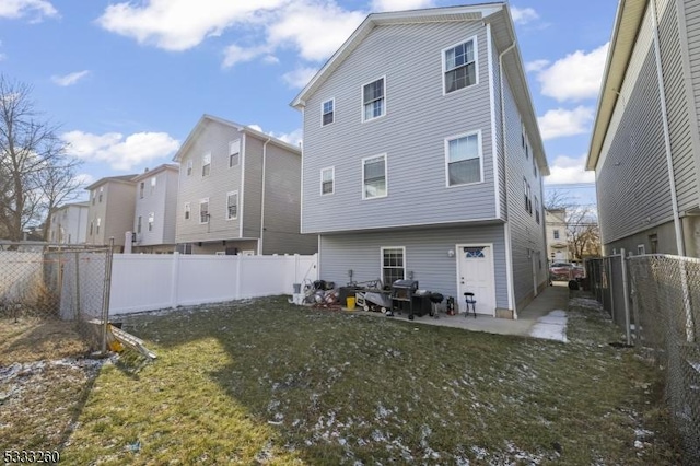 rear view of house featuring a patio and a yard