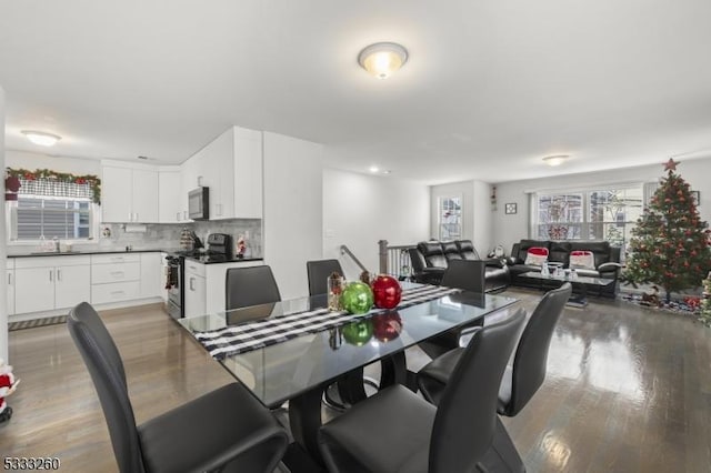 dining space with sink and hardwood / wood-style floors