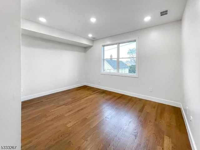 empty room with hardwood / wood-style flooring