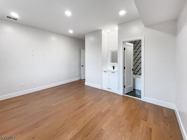 interior space featuring sink and light hardwood / wood-style flooring