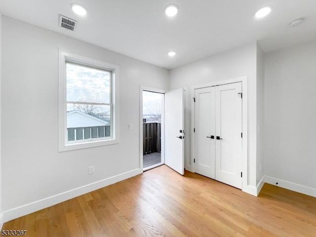 unfurnished bedroom featuring a closet and light wood-type flooring