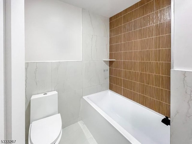 bathroom featuring a washtub, tile walls, and toilet