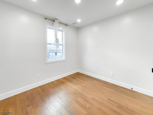 empty room with hardwood / wood-style floors