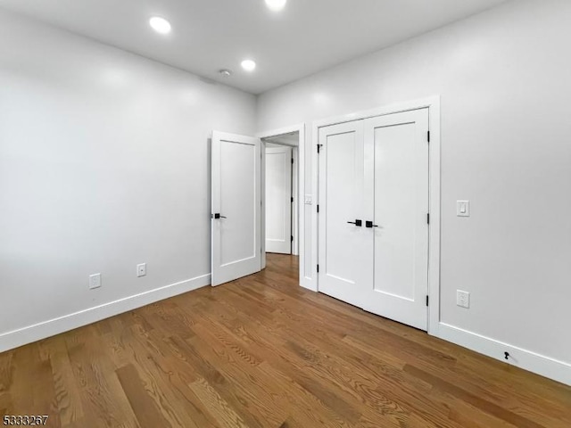 unfurnished bedroom with wood-type flooring