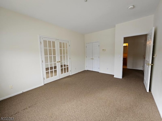 carpeted empty room featuring french doors