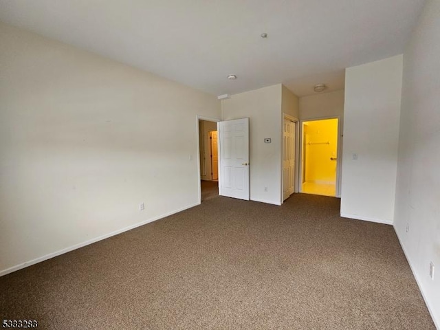 unfurnished bedroom featuring dark carpet