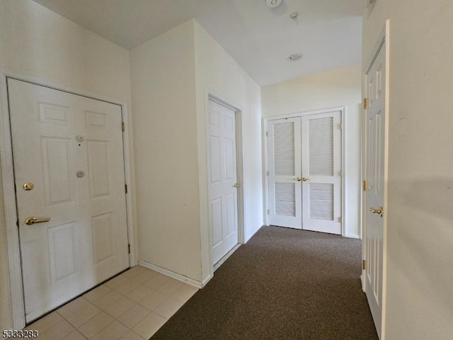 hallway with light carpet and french doors