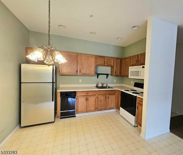 kitchen with electric range oven, dishwasher, decorative light fixtures, sink, and stainless steel refrigerator