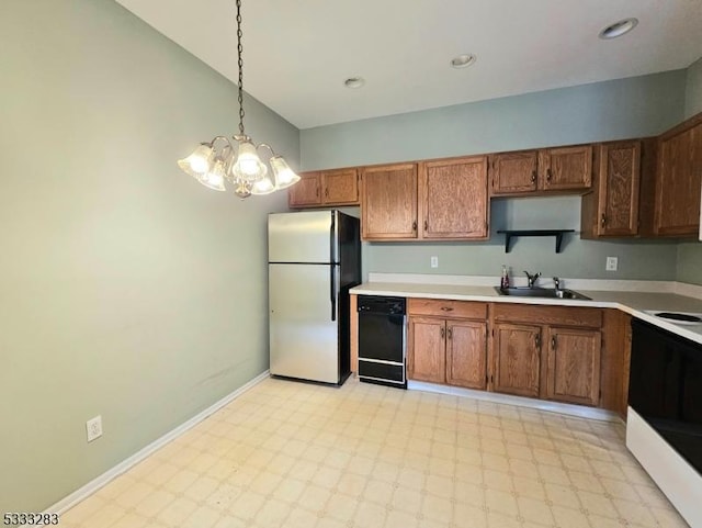 kitchen with black dishwasher, stainless steel refrigerator, electric range oven, pendant lighting, and sink