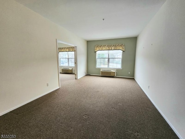 carpeted empty room with an AC wall unit